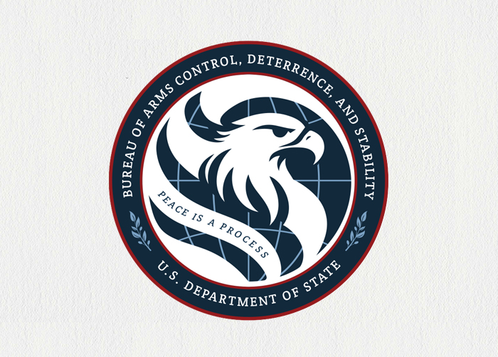 An eagle is part of and emerges from the waving stripes of the flag.